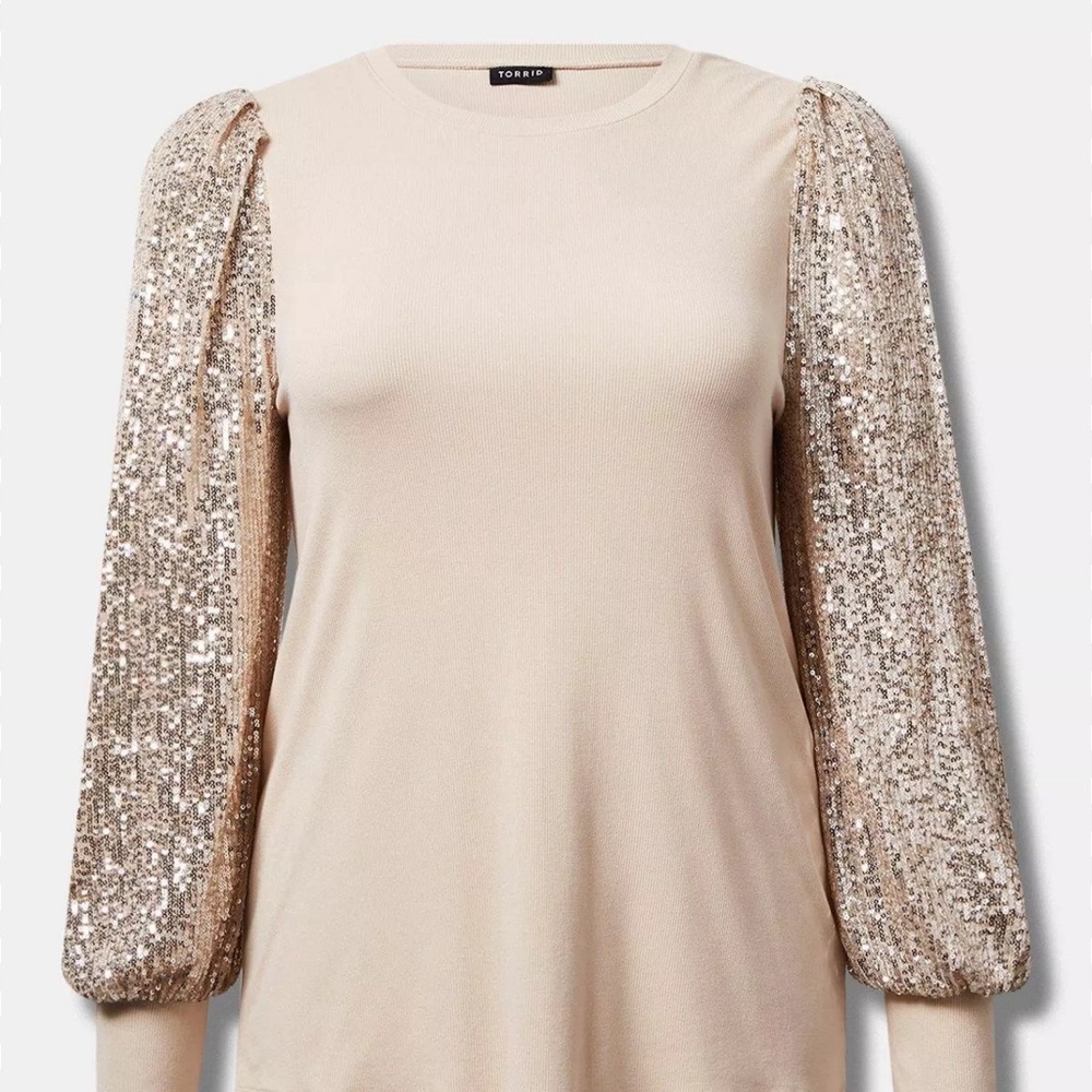 Crew neckline.
Sequin blouson sleeves. 
Ribbed details.